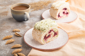 Roll biscuit cake with cream cheese and jam, cup of coffee on brown concrete, side view.