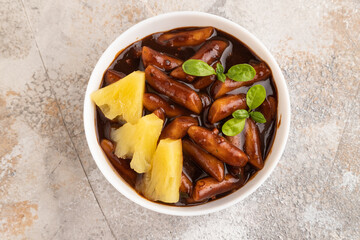 Tteokbokki or Topokki, fried rice cake stick, on gray concrete, top view