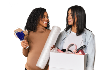 Two Latin women, one pregnant, with moving box in studio
