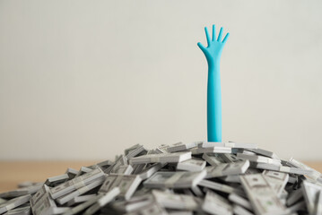 Need help arm on US dollar bill banknotes pile with white wall background. Business bankruptcy,...