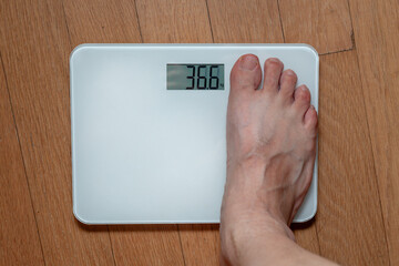 A person measuring weight on a scale
