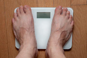 A person measuring weight on a scale