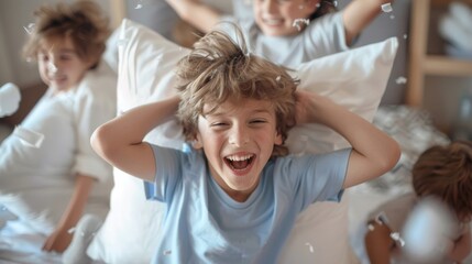 Playful boy having a pillow fight with his siblings,  laughing and bonding together