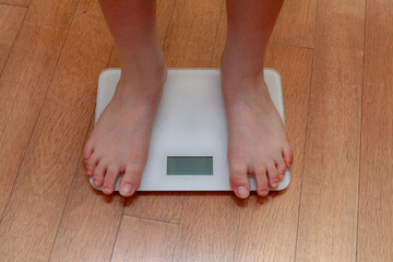 A person measuring weight on a scale