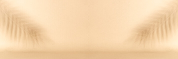 Long wide banner with abstract unfocused palm leaves on light beige background with copy space for your design. Summer beach background concept. Cosmetic branding banner.