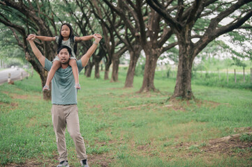 Obraz premium Happy father and daughter hugging while standing at countryside,Father'day concept,enjoying tender moment