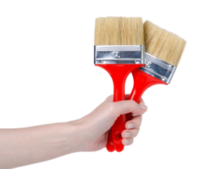 Red paint brushes in hand on white background isolation