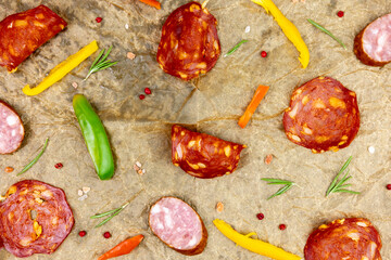 Chorizo salami pattern with vegetables on cooking paper top view