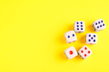 Many white game dices on yellow background, flat lay. Space for text