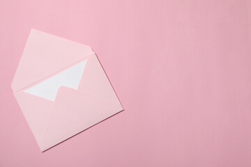 Letter envelope with card on pink background, top view. Space for text