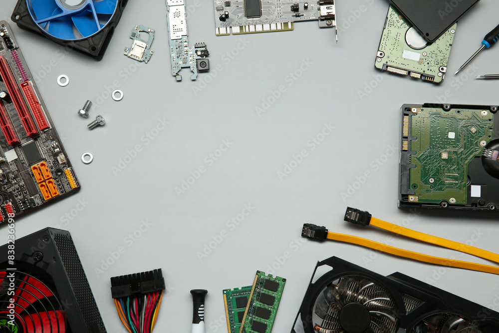 Fototapete frame of graphics card and other computer hardware on light background, flat lay. space for text