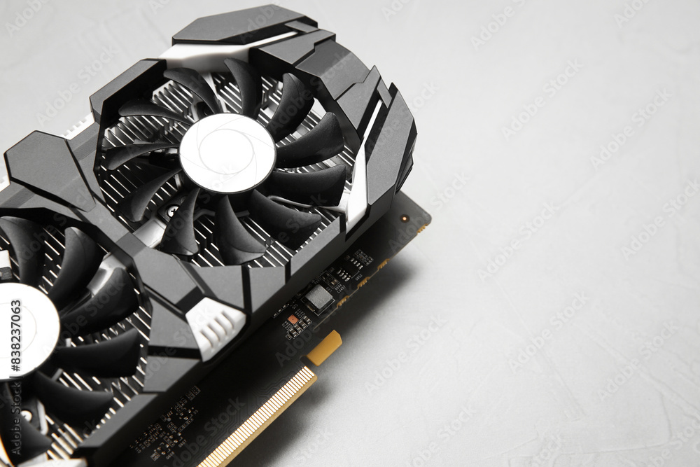 Fototapete computer graphics card on gray textured background, above view. space for text