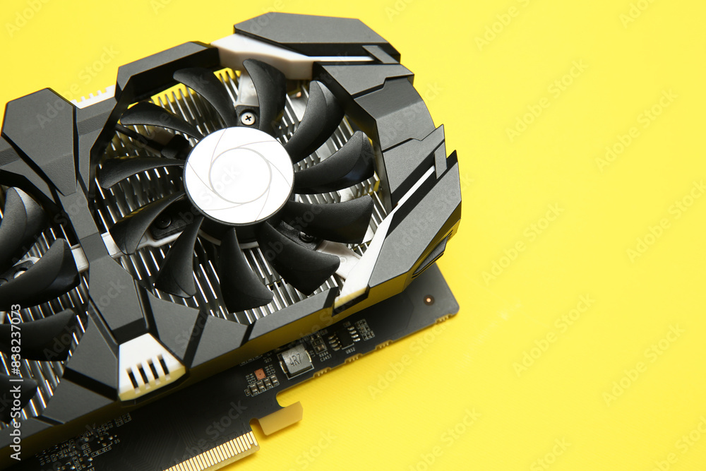 Fototapete computer graphics card on yellow background, above view. space for text