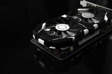 Computer graphics card on dark mirror surface, closeup