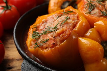 Tasty stuffed peppers in pan on table, closeup