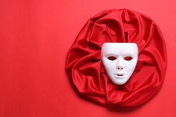 Theater arts. White mask and fabric on red background, top view. Space for text