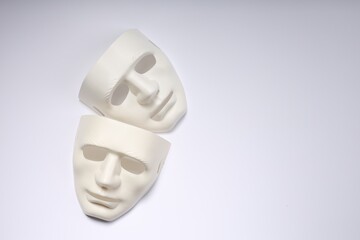 Theater arts. Two masks on white background, top view. Space for text