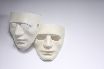 Theater arts. Two masks on white background, above view. Space for text