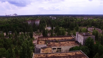Aerial view. The city of Pripyat. View of the Chernobyl nuclear power plant through abandoned...