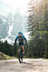 mountain biking in the snowing mountains of the dolomites