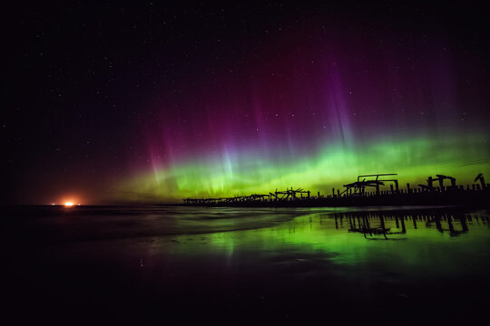Purple and green Northern Lights over Sventoji old pier (Sventosios senasis molas), Sventoji, Palanga, Lithuania