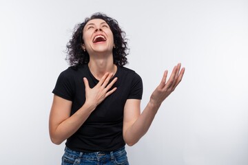 Portrait of a loudly laughing woman with a perm wearing a basic T-shirt