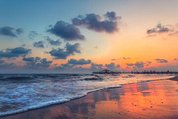 Sunset over a beach and distant pier, Side, Antalya, Turkey