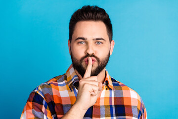 Photo of nice young man show shush gesture wear shirt isolated on blue color background