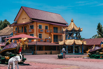 A tourist visiting Wat Phothikyan Phutthaktham Thai White Buddha Statue Monastery in Kota Bharu, Malaysia