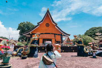 A tourist visiting Wat Phothikyan Phutthaktham Thai White Buddha Statue Monastery in Kota Bharu, Malaysia