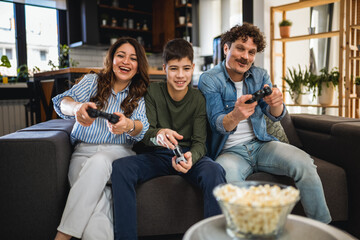 Latino family playing video games with their controllers.