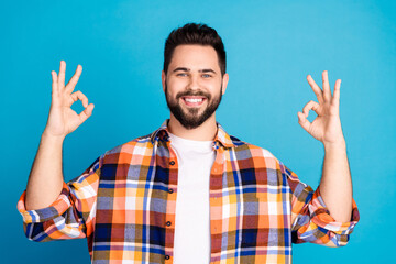 Photo of nice young man show okey symbol wear shirt isolated on blue color background