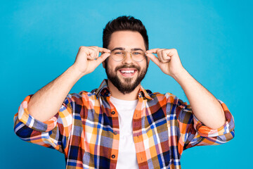 Portrait of nice young man touch glasses wear shirt isolated on blue color background