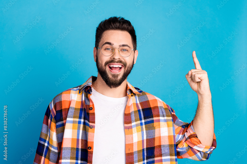 Sticker Photo of nice young man point finger wear shirt isolated on blue color background