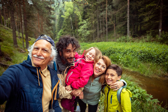 Three generation family selfie during a nature walk in the forest
