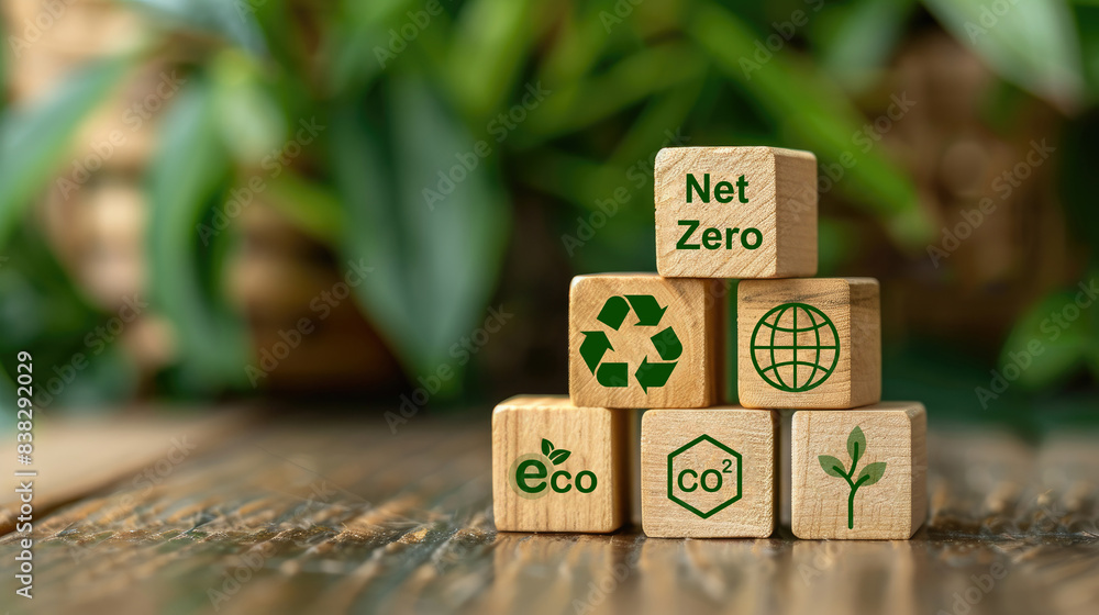 Poster stack of wooden blocks with net zero icons on a green background, highlighting the concept of sustai