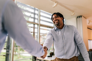 Human Resource congratulates the new employee of their company after the job interview.