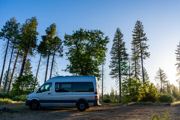 Fototapeta premium Camper van parked in the sierra mountains at sunrise.