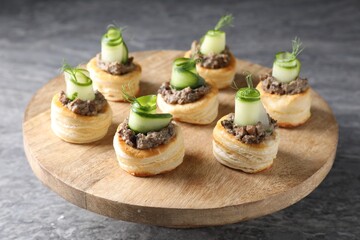 Delicious puff pastry with mushrooms, cucumber and dill on grey table