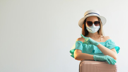 Pandemic holiday. Travel protected. Girl in mask medical gloves summer dress pointing finger at...