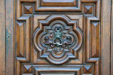 TURIN, ITALY - SEP 14, 2019: Beautiful handmade heavy wooden door, the famous Devil's Door, in the old town of Turin