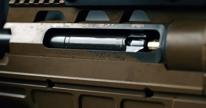 Super slow motion close up of empty bullet shell casing is flying out of machine fire gun during training in a shooting range. Shooting and Weapons
