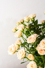 A bouquet of delicate cream roses close up, home decoration with flowers, a festive bouquet of roses for a birthday or wedding