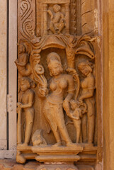 Closeup of  sculpture carved on the wall of Lakshmi Temple in the Khajuraho temple complex, India