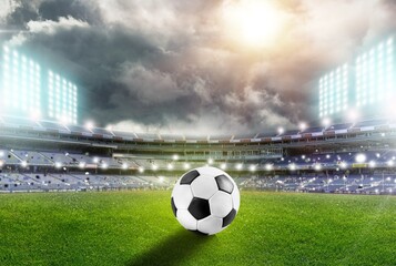 Classic soccer ball on green field in stadium