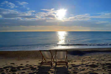 Deckchairs on Beach with Dramatic Sky
