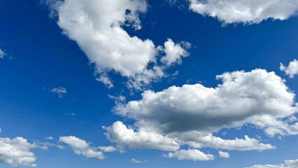 Clear blue sky and white clouds background