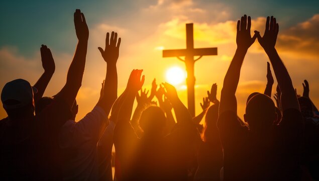 A group of people with their hands raised in worship jesus