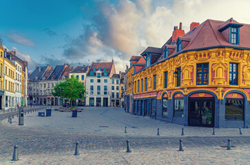 Naklejka premium Vieux Lille old town quarter with empty narrow cobblestone street, paving stone square with old colorful buildings in historical city centre, French Flanders, Hauts-de-France Region, Northern France