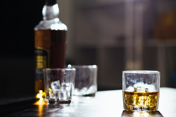 glass of alcohol is left on table after drinking with friends in office after work so that alcohol helps relax mind. Concept of ​​drinking alcohol in moderation and campaigning against drunk driving.